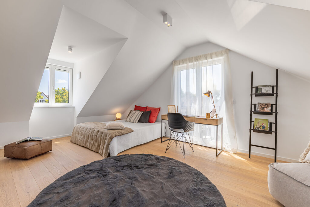 Photo of a teenager's room in the attic of a new twin house in Garching near Munich by DOMINO Bau