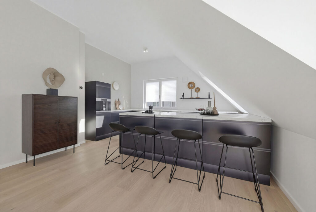 Photo of a kitchen area in the attic of a three-unit apartment building by DOMINO Bau in Munich Solln